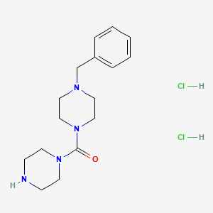 1-Benzyl-4-(piperazine-1-carbonyl)piperazine dihydrochloride - 1989672-19-6